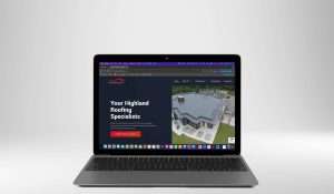 A laptop displaying a website for Highland Roofing Specialists. The homepage highlights Inverness Businesses, featuring a roofing service description and an aerial photograph of a house with a newly installed roof.