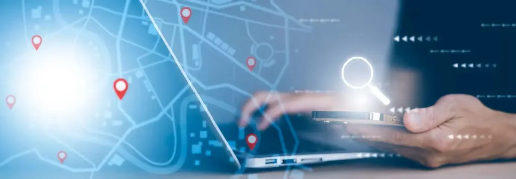 A person using a laptop and holding a smartphone with an overlay of a digital map and location markers, along with a glowing magnifying glass icon, showcasing how WordPress Design can transform user journeys.