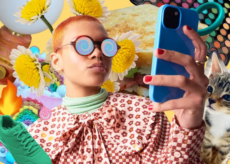A person with round glasses snaps a selfie using a blue phone, surrounded by colorful elements like a cat, sneaker, and daisies in a vibrant collage. This lively scene is as dynamic as future-proof marketing strategies that keep Inverness businesses ahead of the curve.